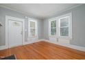 Bright living room features hardwood floors and large windows offering lots of natural light at 907 Holloway St, Durham, NC 27701
