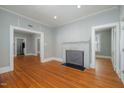 Spacious living room with hardwood floors, fireplace, and open doorways for easy flow at 907 Holloway St, Durham, NC 27701