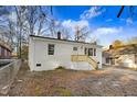A charming one-story home with a brick chimney and freshly painted white exterior at 916 Tyan St St, Rocky Mount, NC 27801