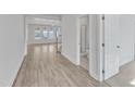 Bright hallway leading to bathroom with wood flooring and white molding at 9168 Dupree Meadow Dr # 15, Angier, NC 27501