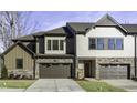 Stunning townhome featuring stone accents, gray garage doors, and well-maintained lawns at 960 Double Helix Rd, Apex, NC 27523
