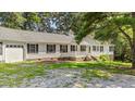 Charming ranch-style home with white siding, black shutters, and a welcoming front porch at 98 Beach Ln, Henderson, NC 27537