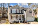 Beautiful two-story home featuring a cozy front porch and attached two car garage at 1007 Olde Midway Ct, Knightdale, NC 27545