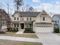 Charming two-story home with a welcoming front porch and attached two-car garage at 1009 Bexley Hills Bnd, Apex, NC 27502