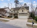 Lovely two-story home featuring an inviting front porch, a two-car garage, and a spacious driveway at 1009 Bexley Hills Bnd, Apex, NC 27502