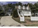 Quaint home with a well-kept lawn and a welcoming white picket fence at 104 Province Cir, Rocky Mount, NC 27804