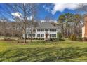Beautiful two-story home with black shutters, mature trees, and a well-maintained front lawn at 106 Legault Dr, Cary, NC 27513