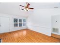 Spacious living area featuring hardwood floors, white walls, large windows, and vaulted ceiling at 12491 Buffalo Rd, Archer Lodge, NC 27527