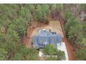 Aerial view of a stately home with fenced backyard, fire pit, inground pool and lush greenery at 170 Pine Cone Loop, Pittsboro, NC 27312