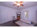 Bright bedroom featuring hardwood floors, two windows, ceiling fan, and interior door at 1805 Shelton Ave, Durham, NC 27707