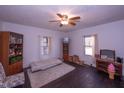 Bright bedroom featuring hardwood floors, two windows, ceiling fan, and room for relaxing at 1805 Shelton Ave, Durham, NC 27707