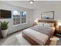 This bright bedroom features a large window and a television on the wall at 20 Beechnut Ct, Franklinton, NC 27525