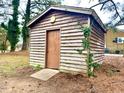 Rustic shed with wooden siding, providing outdoor storage or hobby space at 201 W Thorndale Dr, Oxford, NC 27565