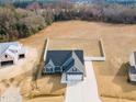 Aerial view of home with spacious yard, long drive, and a white wooden fence at 220 Pepperdam St, Smithfield, NC 27577