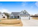 Charming home with a two-car garage, manicured lawn and craftsman design elements at 220 Pepperdam St, Smithfield, NC 27577