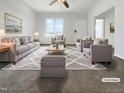 Bright living room featuring neutral tones, with a large window allowing for ample natural light at 265 Freeman Pines Pl, Fuquay Varina, NC 27526