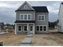 Charming two-story home with gray siding, black roof, and a welcoming front porch at 265 Marvel Dr # 137, Rolesville, NC 27571