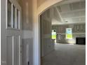 Bright living room with large window, a modern fireplace and unfinished drywall at 28 Golden View Pl, Zebulon, NC 27597
