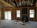 Living room framing with fireplace, windows, and sliding glass door at 28 Golden View Pl, Zebulon, NC 27597