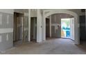 Spacious living room featuring unfinished drywall, and an arched doorway at 28 Golden View Pl, Zebulon, NC 27597