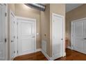 Hallway featuring hardwood floors, several doors, and an industrial-style exposed ventilation system at 300 Finsbury St # 313, Durham, NC 27703