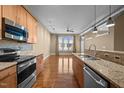 Bright kitchen featuring stainless steel appliances, granite countertops, and hardwood flooring throughout the open concept at 300 Finsbury St # 313, Durham, NC 27703