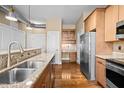 Well-equipped kitchen with stainless appliances, granite countertops, and a built-in desk area for added convenience at 300 Finsbury St # 313, Durham, NC 27703