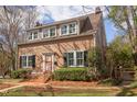 Charming two-story home with mature landscaping, brick entrance, and multiple windows at 300 Mccauley St, Chapel Hill, NC 27516