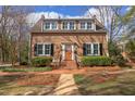 Inviting two-story home with brick walkway, orange door and manicured landscaping at 300 Mccauley St, Chapel Hill, NC 27516