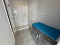 Bathroom features modern shower, gray tile floor and vanity with covered counter-top at 307 Chesapeake Commons St # 100, Garner, NC 27529