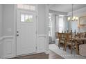 Bright dining room featuring a decorative chandelier, dining table and chairs and natural light at 31 Priming Way, Angier, NC 27501