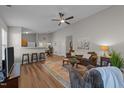 Open-concept living room with hardwood floors, a ceiling fan, and neutral color scheme at 312 Homestead Park Dr, Apex, NC 27502