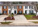 Charming townhomes with well-maintained lawns, mature trees, and updated exterior finishes at 3122 Coxindale Dr, Raleigh, NC 27615