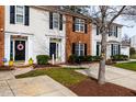 Well-kept townhomes showcase a mix of brick and siding, enhanced by lush landscaping and mature trees at 3122 Coxindale Dr, Raleigh, NC 27615