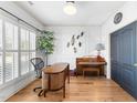 Bright office space with hardwood floors, plantation shutters, and a decorative accent wall at 3124 Elm Tree Ln, Raleigh, NC 27614