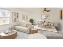 Bright and airy living room featuring modern decor, stylish furnishings, and a dining area at 325 Bainbridge Cir, Garner, NC 27529