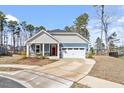 Charming single-Gathering home with a mix of siding, stone accents, and a two-car garage at 3424 Writt Ct, New Hill, NC 27562
