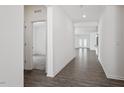 Bright hallway with hardwood floors leading to spacious living areas, showcasing the home's open layout at 3424 Writt Ct, New Hill, NC 27562