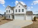 Charming two-story home with a three-car garage and well-manicured landscaping at 350 Arlie Ln, Lillington, NC 27546