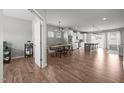 Open-concept living area with hardwood floors, modern lighting, and seamless flow to the kitchen at 350 Arlie Ln, Lillington, NC 27546