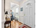 Inviting foyer with hardwood floors, white trim, and a view into the living area at 3523 Elk St, Burlington, NC 27215