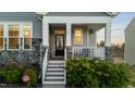 Inviting front porch with classic white railing, stone columns, and decorative details that give it curb appeal at 363 Grey Hawk Dr, Garner, NC 27529