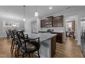 Spacious kitchen island with bar stool seating, stainless appliances, and contemporary finishes create a perfect space at 363 Grey Hawk Dr, Garner, NC 27529