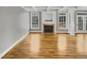 Bright living room with hardwood floors, fireplace, and large windows at 4023 Cashew Dr, Raleigh, NC 27616