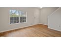 Bright living room with hardwood floors and large window, creating an inviting atmosphere at 4201 Hampstead Village Dr, Durham, NC 27703