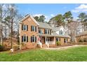 Charming brick two-story home featuring a well-manicured lawn and classic architectural details at 5008 Sunset Forest Cir, Holly Springs, NC 27540