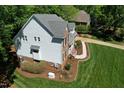 Aerial view of two-story home featuring brick and vinyl siding and mature landscaping at 5008 Sunset Forest Cir, Holly Springs, NC 27540