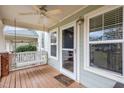 Close-up of cozy front porch featuring a swing, ceiling fan, and a welcoming 'Home Sweet Home' mat at 521 Eastway Ave # Apt B, Durham, NC 27703
