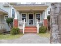 Inviting front porch with classic railing, porch swing, and charming details at 521 Eastway Ave # Apt B, Durham, NC 27703
