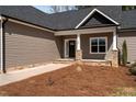 Inviting entryway with stone-accented columns and a well-defined walkway to the front door at 649 Pendergrass Rd, Sanford, NC 27330